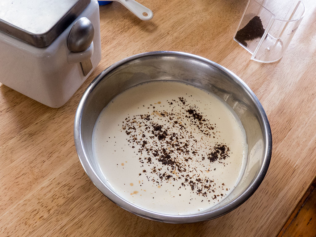 Add the coffee grounds and vanilla to the strained custard mix