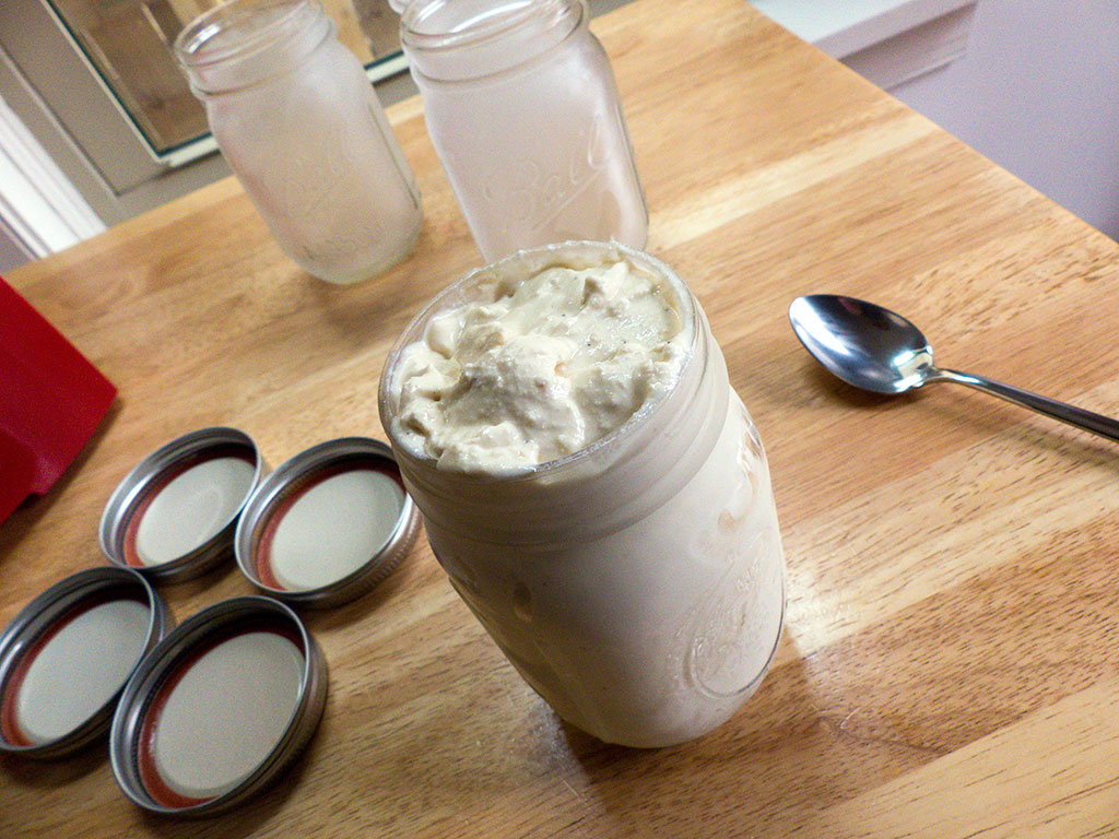The finished coffee ice cream goes into chilled Mason jars
